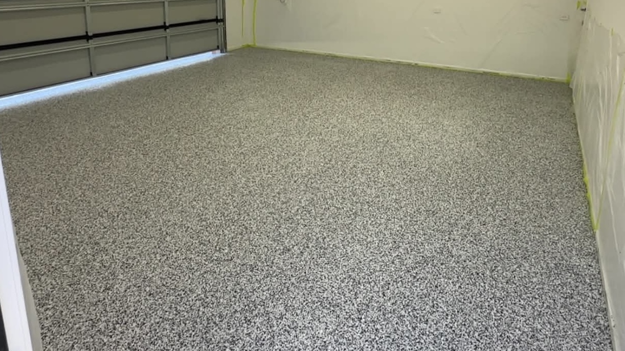 Speckled grey epoxy floor finish inside a residential garage by Tom Body Concrete