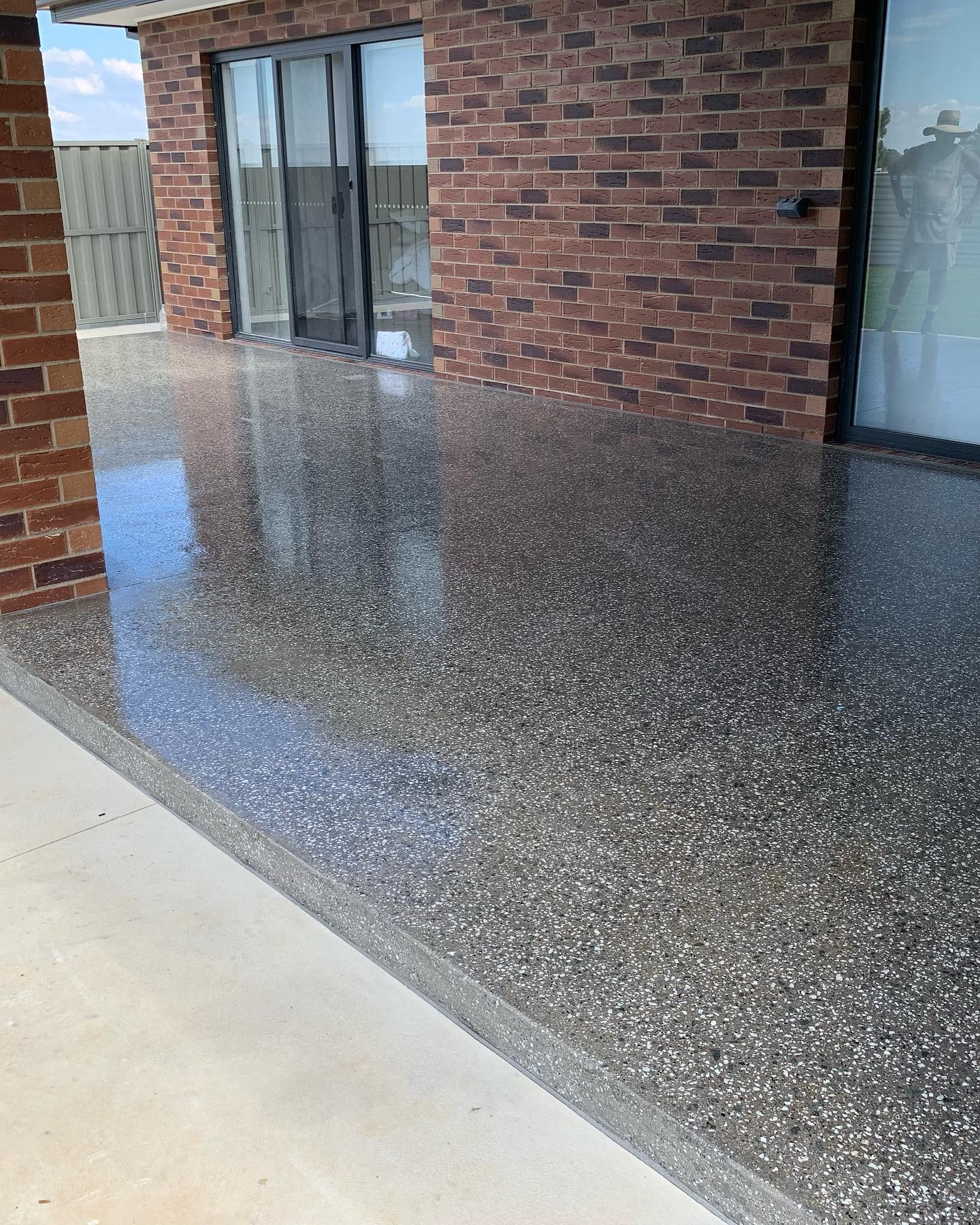 Polished exposed aggregate alfresco floor completed by Tom Body Concrete